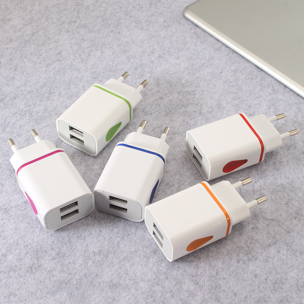 Five USB power adapters with colored accents on a gray surface