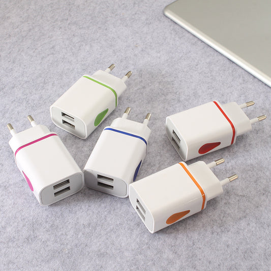 Five USB power adapters with colored accents on a gray surface