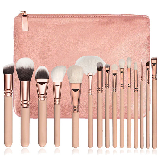 Set of makeup brushes with rose gold handles and silver ferrules, displayed against a pink pouch.