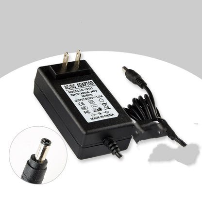 Black AC/DC adapter with power cord on a white background