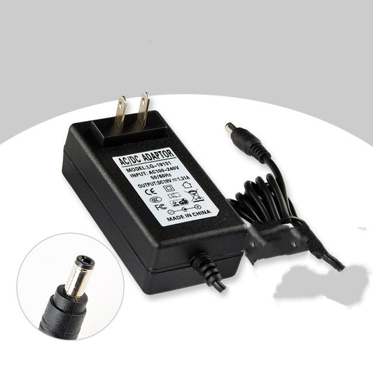 Black AC/DC adapter with power cord on a white background