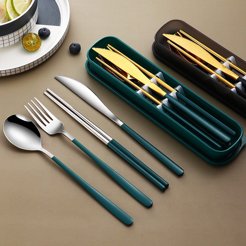 Set of silverware with green handles on a beige surface, including a knife, fork, and spoon.