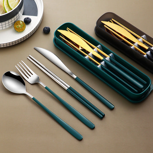 Set of silverware with green handles on a beige surface, including a knife, fork, and spoon.