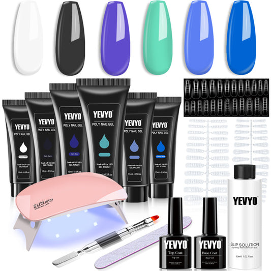 Nail gel polish kit with various bottles, a lamp, and tools on a white background
